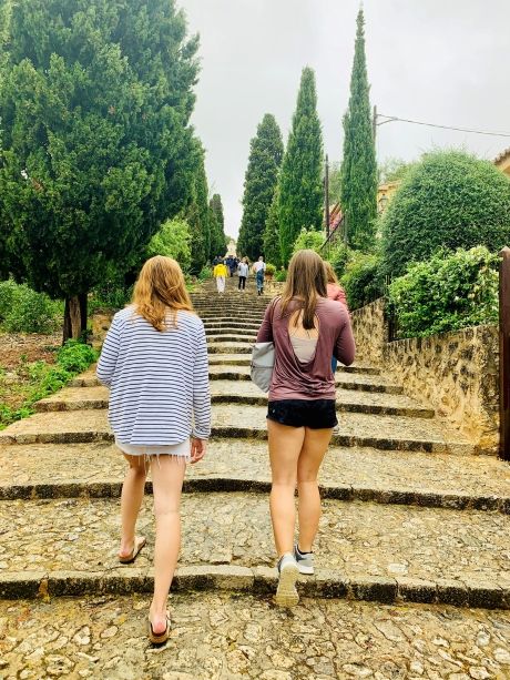Students walking up stairs in a garden