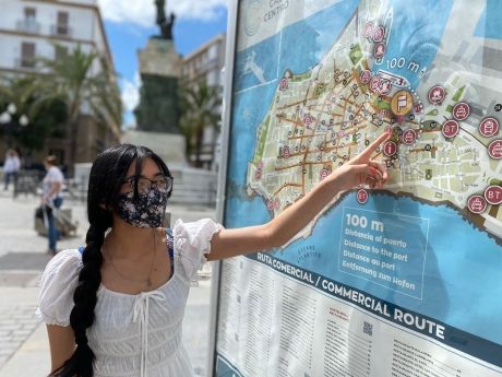 Student pointing at map on street in Spain