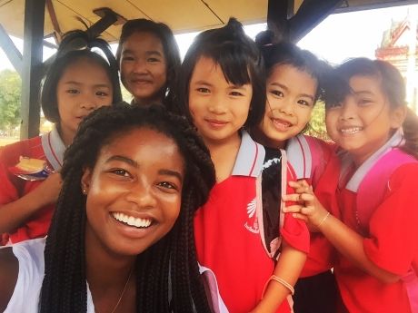 Teacher with group of kids in Thailand