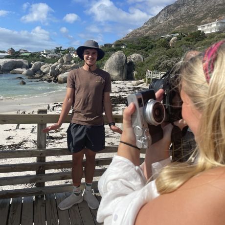 students take photos of each other abroad cape town
