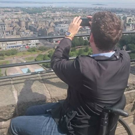 edinburgh student at city overlook taking photo