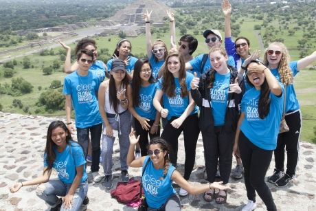 High schoolers wearing Global Navigators shirts smiling in Mexico