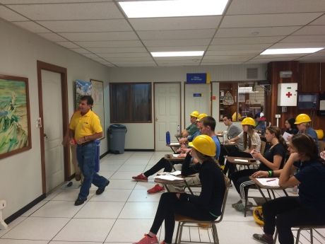 High school students in classroom wearing hardhats