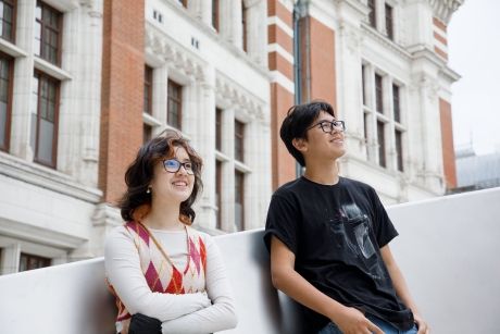 High school students leaning against a wall in London