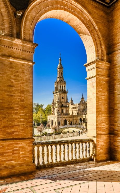 Seville cityscape through a gilded archway