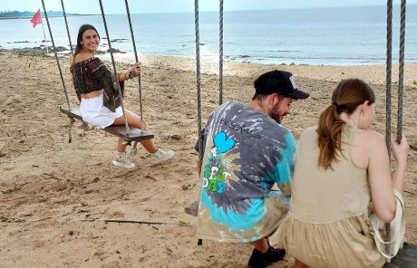 students swing on beach abroad singapore