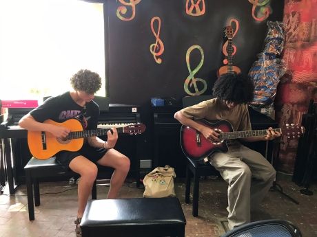 Students playing guitar in Moroccan cafe