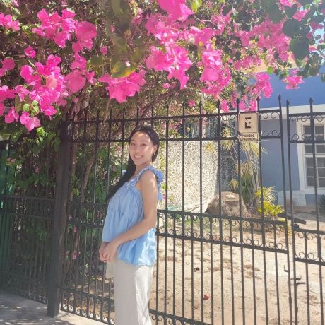 yucatan female student pink flowers outside