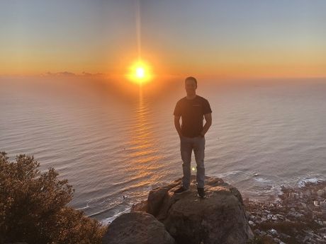 Student at lions head in cape town at sunset