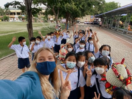 Teacher and students outside in masks in Thailand