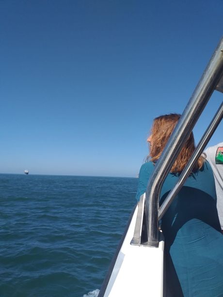Teacher looking out on the ocean from a boat