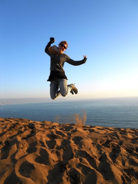 Teach participant in Valparaiso jumping on the beach