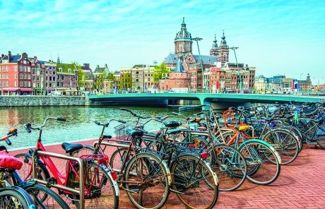 bikes along amsterdam canal sunny day