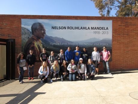 High school students posing with Nelson Mandela mural in Cape Town