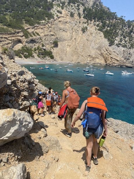 High school students with backpacks walking down to the beach in Palma de Mallorca