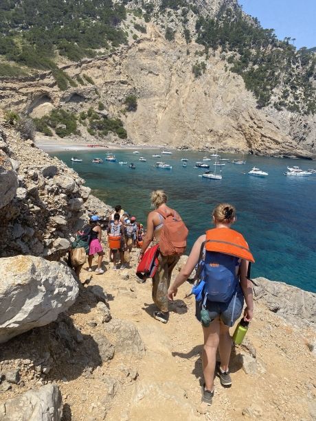 High school students with backpacks walking down to the beach in Palma de Mallorca