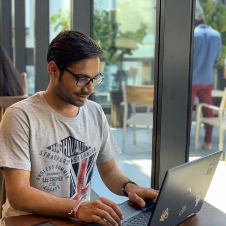 London intern working on laptop in cafe