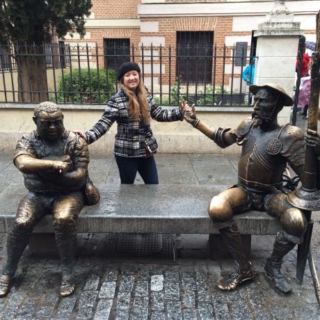 student with statues highfive alcala spain
