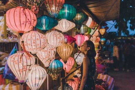 Woman looking at colorful lanterns in Vietnam