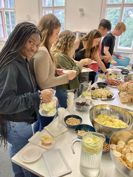 High school students picking up snacks in Prague classroom