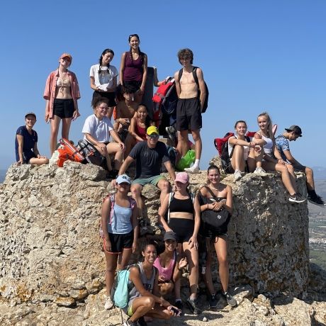 palma students sitting on large rock