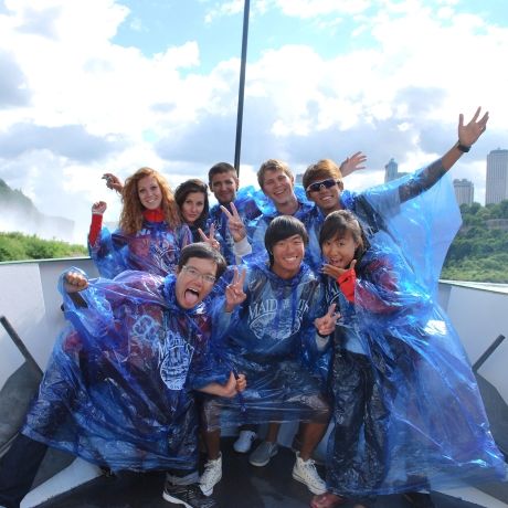 singapore students wearing ponchos on a boat