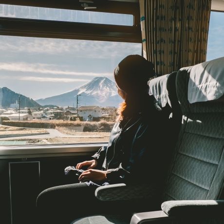 tokyo student on a train looking out window at Mt. Fuji