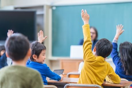 Students raising hands Japan
