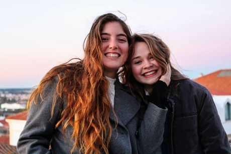 lisbon two girls posing for a photo at sunset