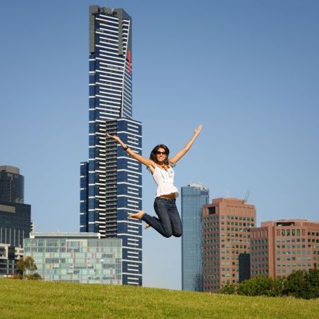 melbourne woman jumping in front of skyscraper