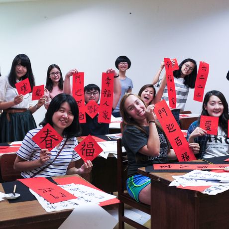taipei students showing off their calligraphy scrolls