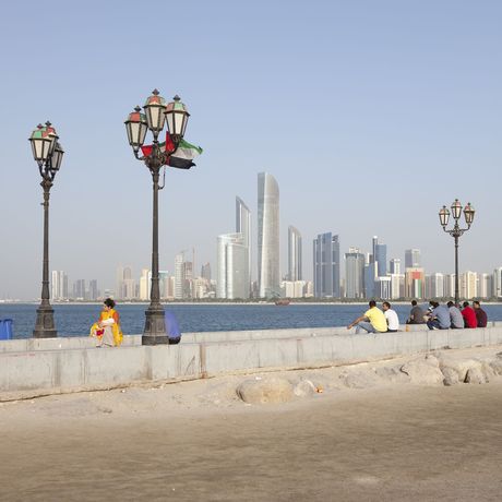 abu dhabi skyline haze people sitting