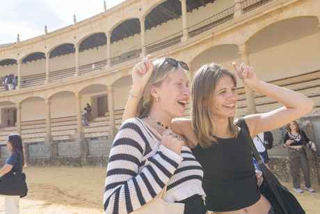 Students posing in old building abroad