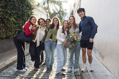 Students smiling in a group on street while studying abroad