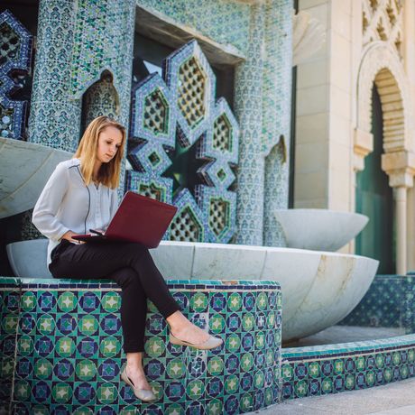 seville-girl-intern-sitting-outside-laptop