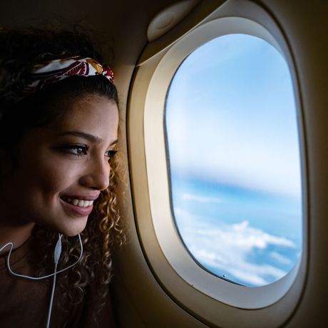 study-abroad-woman-looking-out-airplane-window