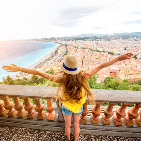 nice-woman-outstretched-arms-overlooking-city