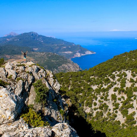 palma-female-student-standing-rocky-crag-overlooking-coastline
