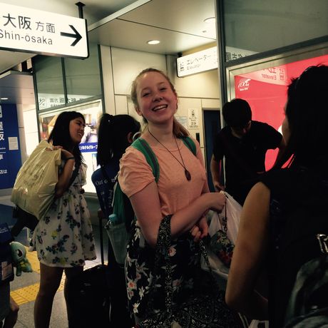Student waits at train platform in Osaka, Japan