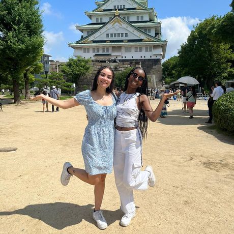 Two female students post in front of Osaka Castle