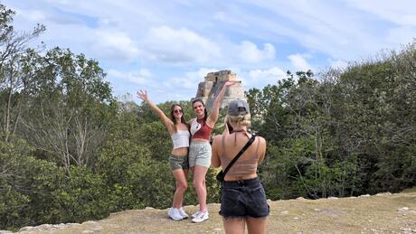 merida-two-female-students-having-picture-taken-another-female-student-chichen-itza