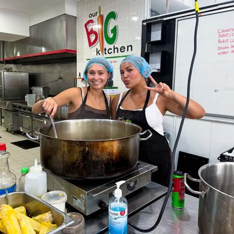 sydney-ccii-two-female-students-stirring-food-our-big-kitchen