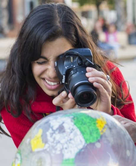 Seville student photographing an inflatable globe