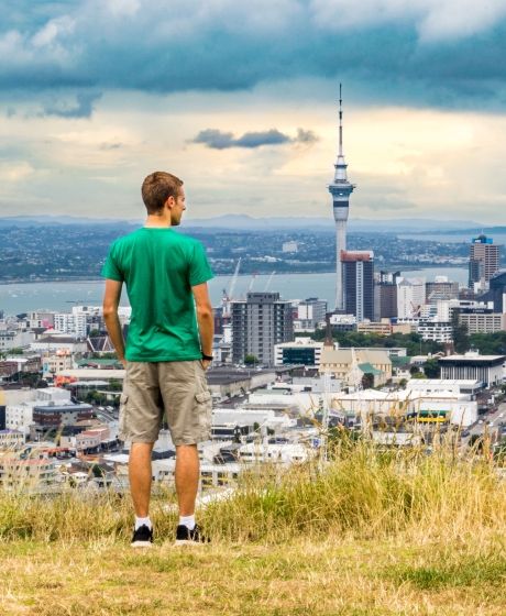 auckland man overlooking sky tower