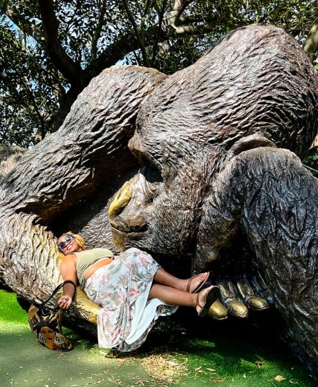 sydney student lying on gorilla statue