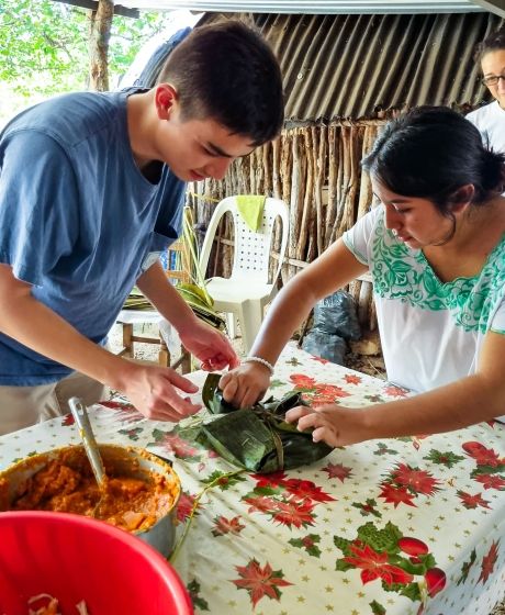 yucatan student learning to wrap food with banana leaves