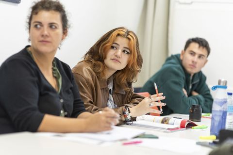 Students focused on lecture in class taking notes