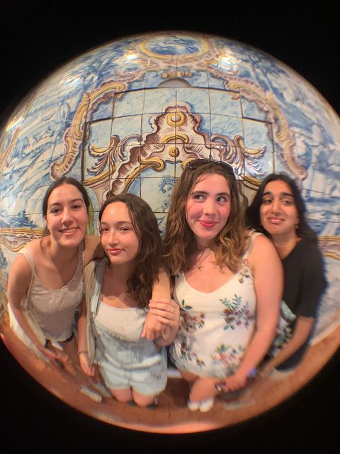 High school students taking a group selfie using a fish eye lens