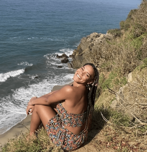 Lizzie in sitting on beach in Mexico
