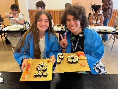 Kyoto program students posing with sushi they made 